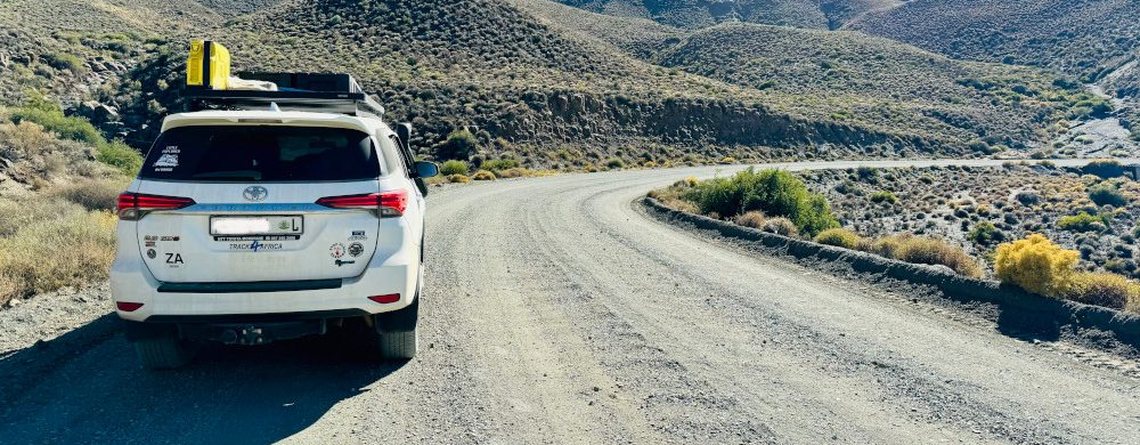 SUV on an open gravel mountain road in South Africa — rent to buy with no mileage limitations