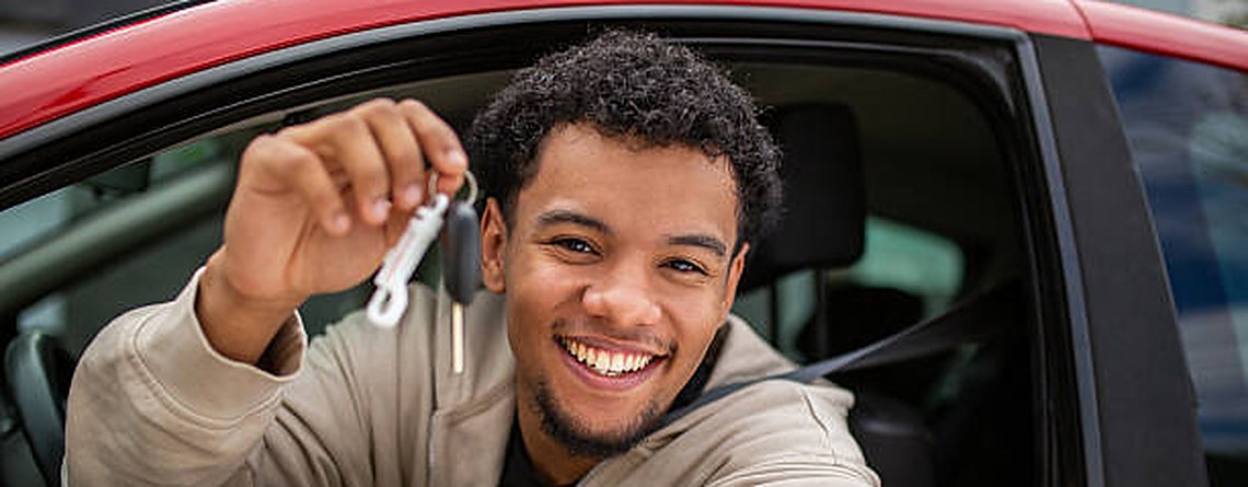Happy driver holding up car keys — own your rent to buy car for R1,500